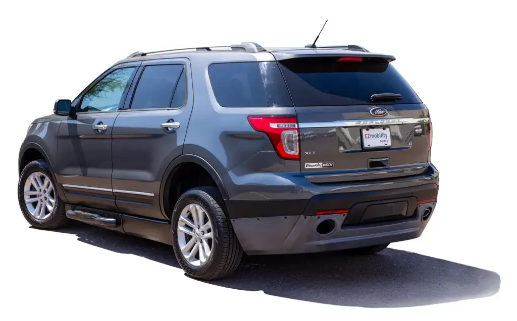 Gray SUV parked on a sunny day, viewed from the rear three-quarter angle, showing a shiny exterior and rear lights.