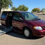 Red Dodge Grand Caravan with BraunAbility Side Entry Automatic Fold Out conversion