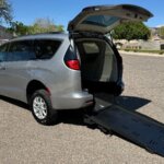 White Chrysler Voyager with Freedom Motors Rear Entry Manual Fold Out conversion