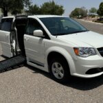 White Dodge Grand Caravan with BraunAbility Side Entry Automatic Fold Out conversion