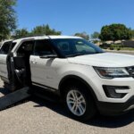 White Ford Explorer with BraunAbility Side Entry Automatic In Floor conversion