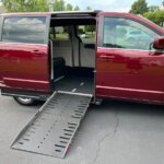 Red Dodge Grand Caravan with Adaptive Vans Side Entry Automatic Fold Out conversion