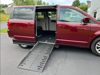 Red Dodge Grand Caravan with Adaptive Vans Side Entry Automatic Fold Out conversion