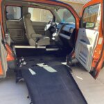 Orange Honda Element with Freedom Motors Side Entry Manual Fold Out conversion