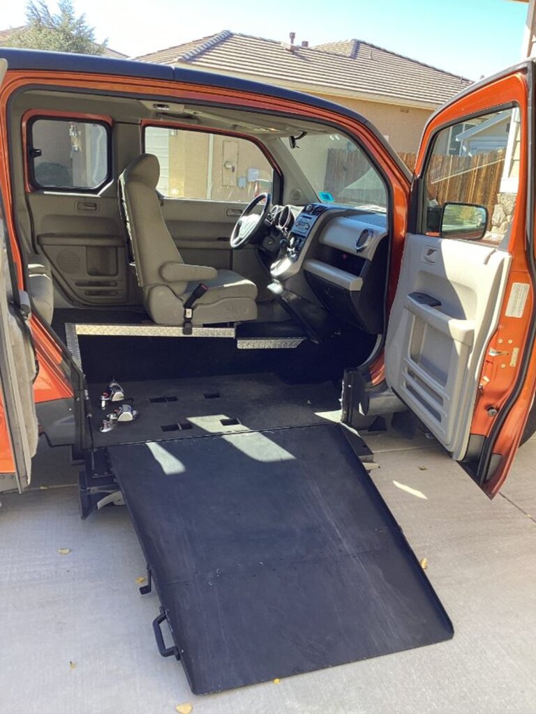 Orange Honda Element with Freedom Motors Side Entry Manual Fold Out conversion