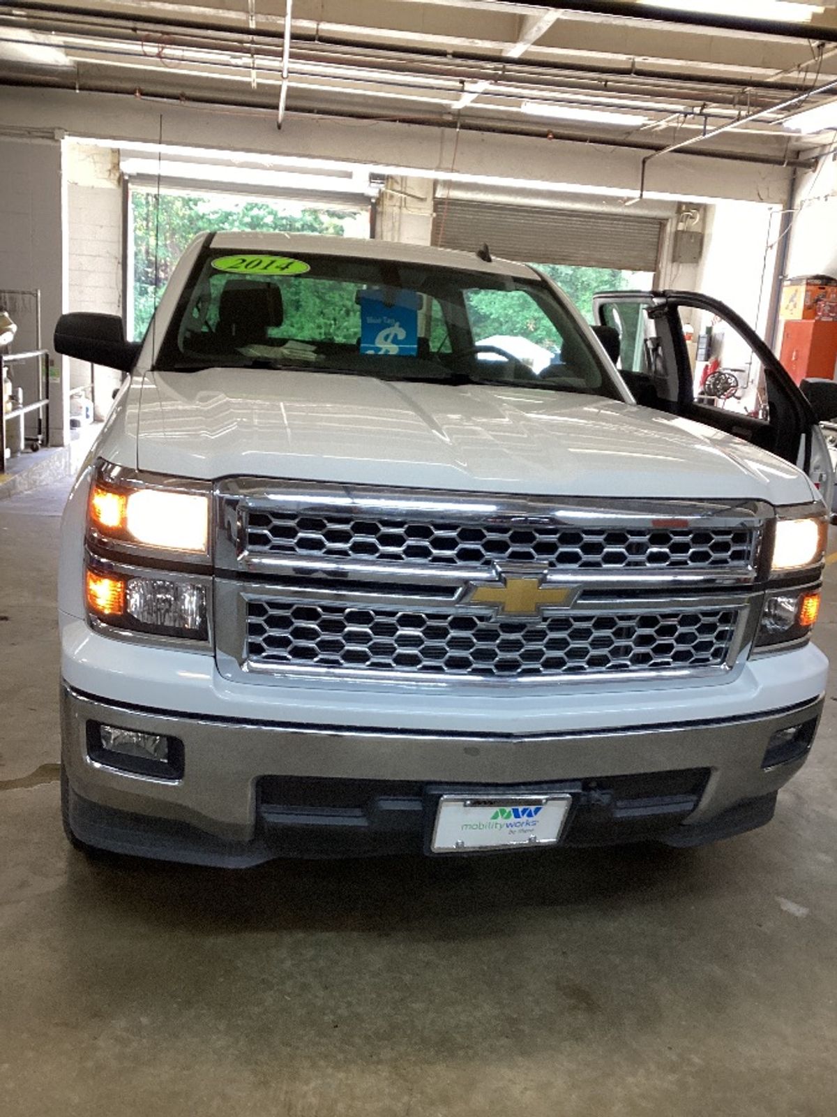 White Chevrolet Silverado 1500 with MobilitySVM Side Entry Automatic Fold Out conversion