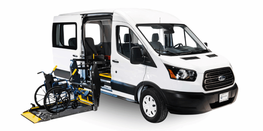 White van with side door open, showing a deployed wheelchair lift and an empty wheelchair positioned on the lift platform.