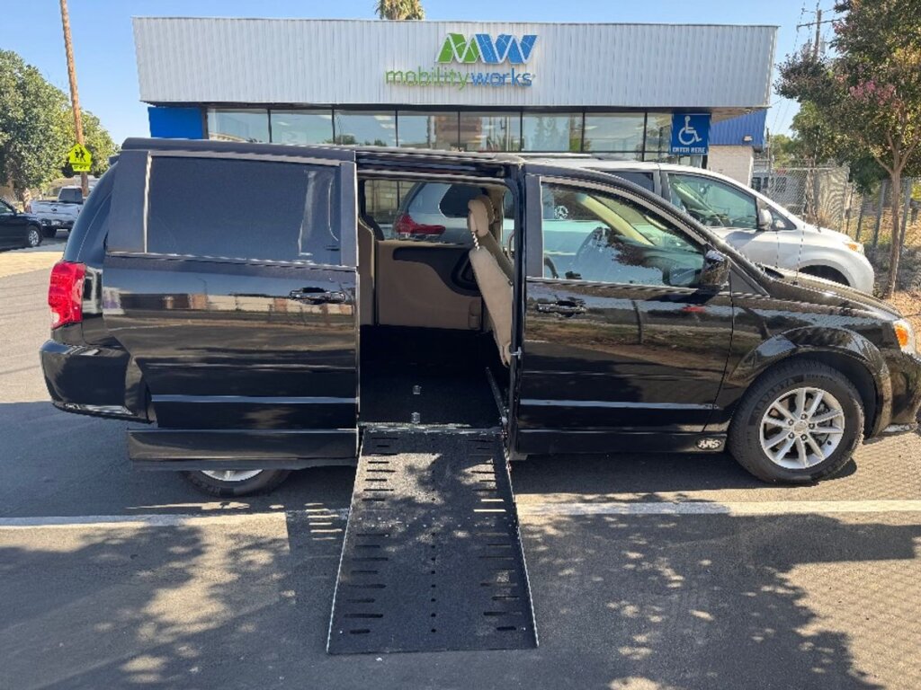 Black Dodge Grand Caravan with Adaptive Vans Side Entry Automatic Fold Out conversion