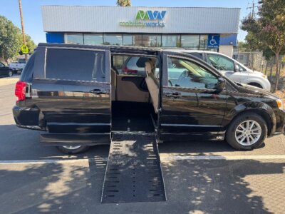 Black Dodge Grand Caravan with Adaptive Vans Side Entry Automatic Fold Out conversion