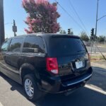 Black Dodge Grand Caravan with Adaptive Vans Side Entry Automatic Fold Out conversion