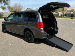 Grey Dodge Grand Caravan with International Sales and Mobility Rear Entry Manual Fold Out conversion
