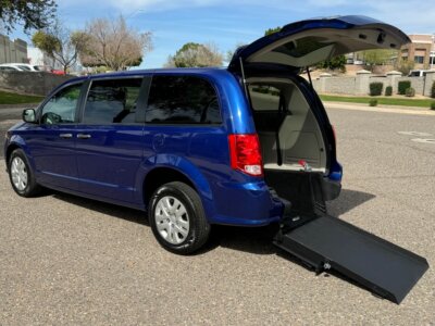 Blue Dodge Grand Caravan with International Sales and Mobility Rear Entry Manual Fold Out conversion