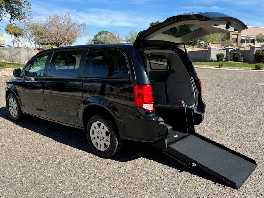 Black Dodge Grand Caravan with International Sales and Mobility Rear Entry Manual Fold Out conversion