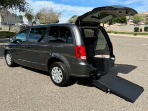 Grey Dodge Grand Caravan with International Sales and Mobility Rear Entry Manual Fold Out conversion