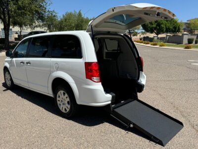 White Dodge Grand Caravan with International Sales and Mobility Rear Entry Manual Fold Out conversion