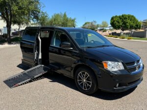 Black Dodge Caravan with Adaptive Vans Side Entry Automatic Fold Out conversion