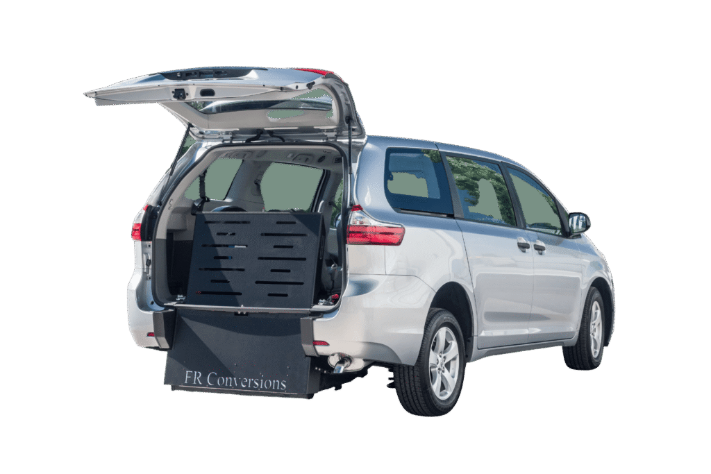 Silver minivan with rear hatch open, featuring a lowered platform and accessible ramp for wheelchair entry; FR Conversions is labeled on the ramp—ideal for those seeking new wheelchair accessible vans.