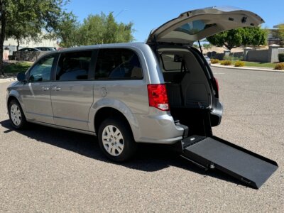 Silver Dodge Grand Caravan with International Sales and Mobility Rear Entry Manual Fold Out conversion