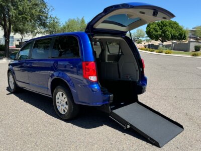Blue Dodge Grand Caravan with International Sales and Mobility Rear Entry Manual Fold Out conversion