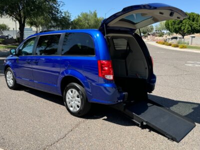 Blue Dodge Grand Caravan with International Sales and Mobility Rear Entry Manual Fold Out conversion