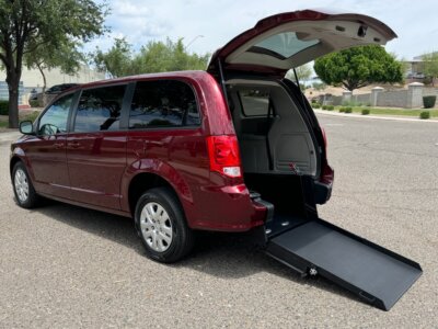 Red Dodge Grand Caravan with International Sales and Mobility Rear Entry Manual Fold Out conversion
