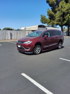 Red Chrysler Pacifica with BraunAbility Side Entry Automatic In Floor conversion