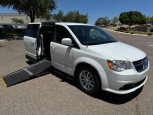 White Dodge Grand Caravan with Driverge Side Entry Automatic Fold Out conversion