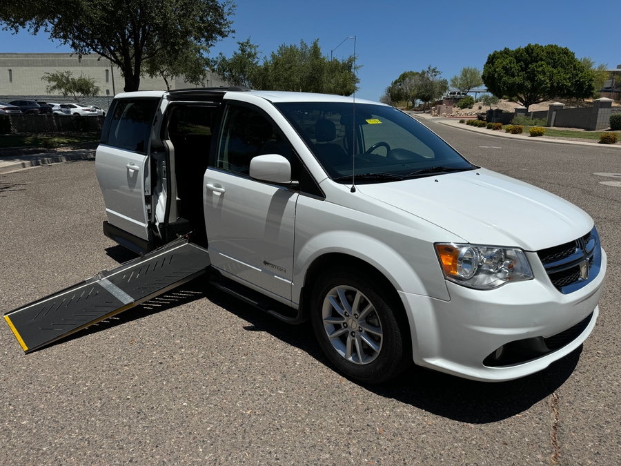 White Dodge Grand Caravan with Driverge Side Entry Automatic Fold Out conversion