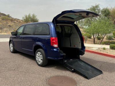 Blue Dodge Grand Caravan with International Sales and Mobility Rear Entry Manual Fold Out conversion